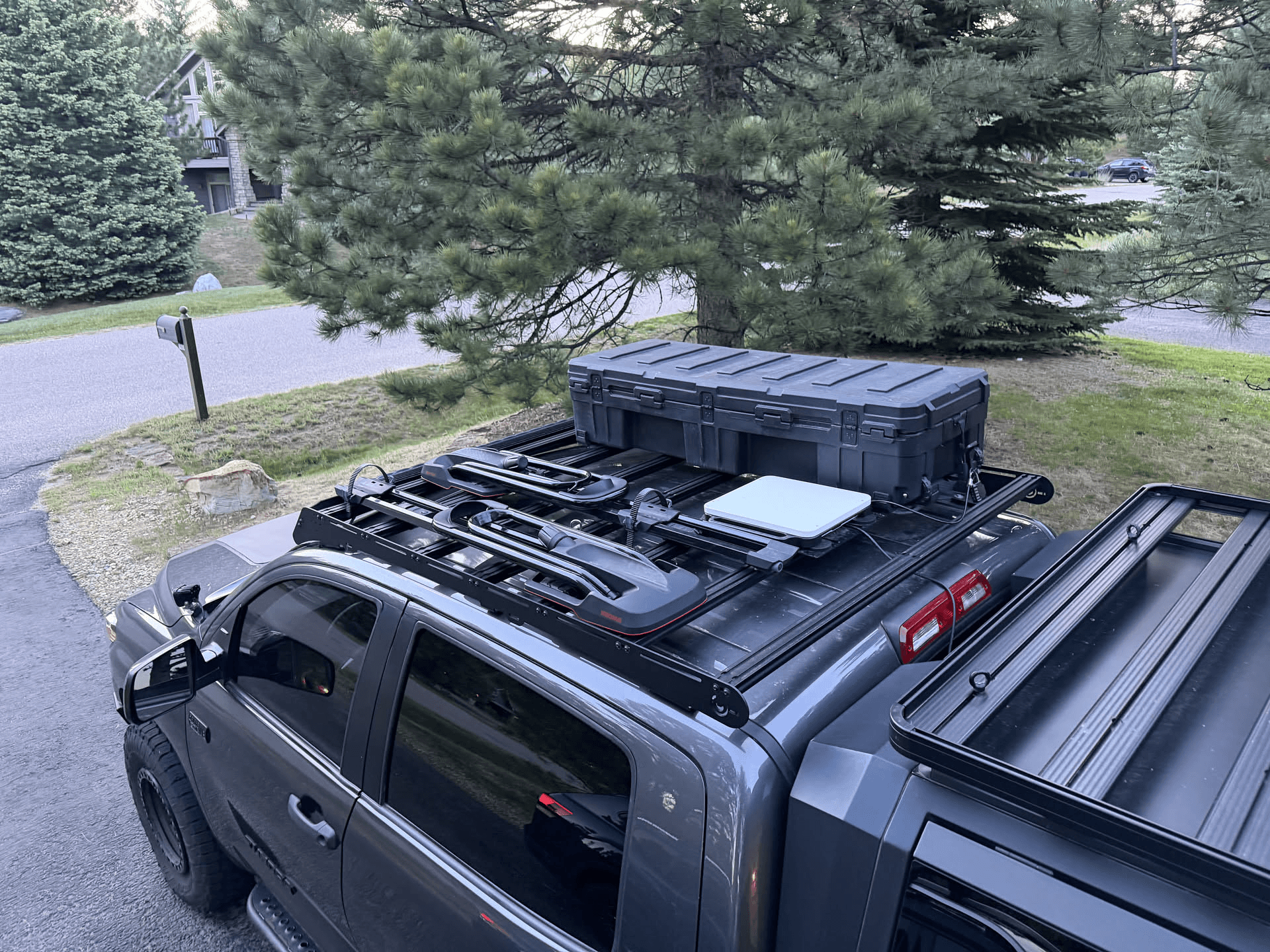 Starlink Magnet Plate installed on a vehicle roof rack beside a Starlink Mini